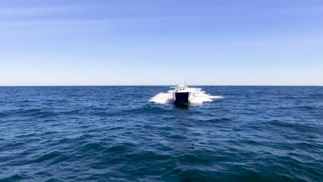 Fast-boat-driving-in-the-open-ocean-over-blue-water