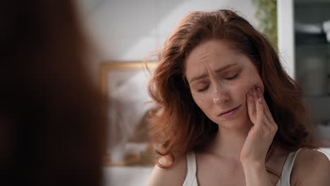 Caucasian-woman-with-huge-toothache-standing-in-the-bathroom.