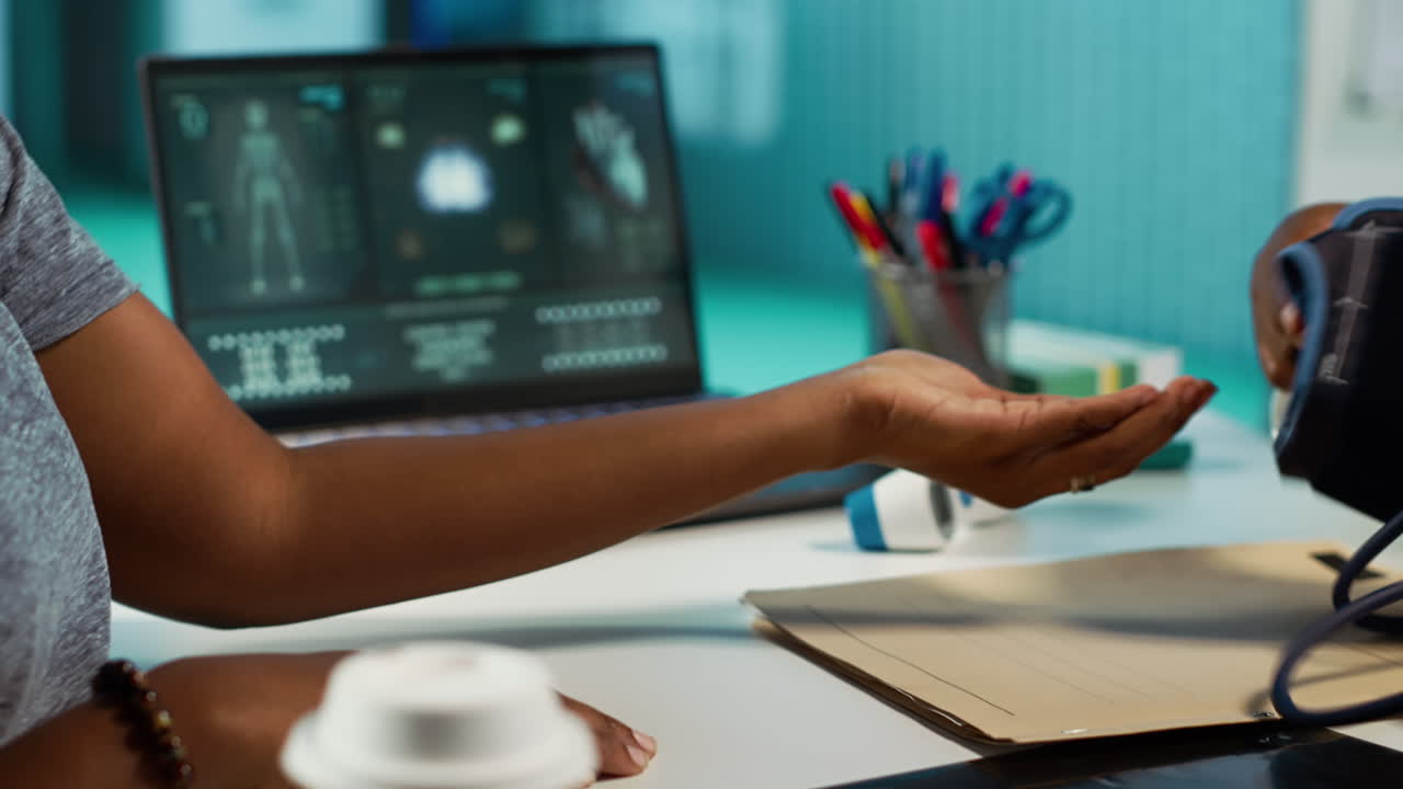 Female physician expert measuring blood pressure at a consultation with girl