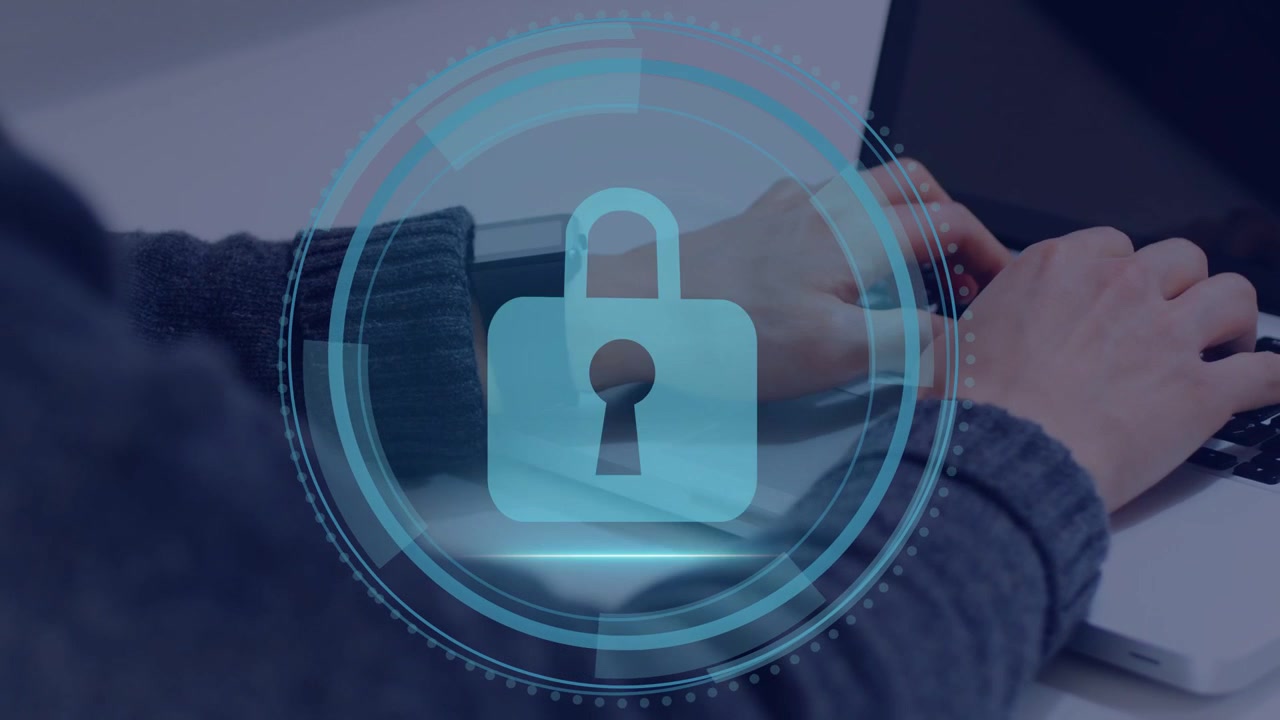 Man typing on laptop, cybersecurity label appearing, HUD rings forming, lock protecting workstation