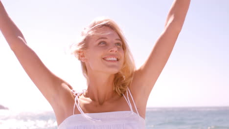 a woman is putting her arms in the air