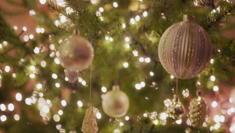 beautiful baubles and warm light of lights on christmas tree