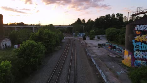 An-Excellent-Aerial-Shot-Of-Railroad-Tracks-Headed-Towards-A-Bridge-In-Asheville-North-Carolina