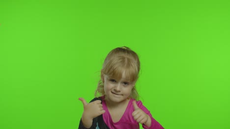 Attractive-kid-ballerina-in-a-silk-tights-show-thumbs-up-in-the-studio-on-chroma-key-background