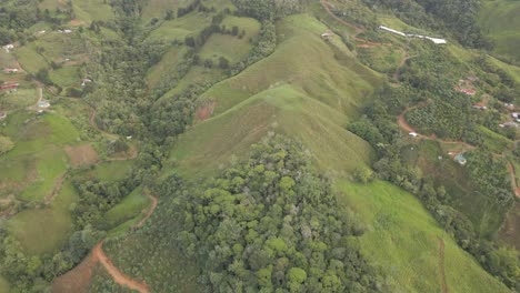a brief ascent up the ridges of a mountain in costa rica featuring the green landscape and red dirt paths