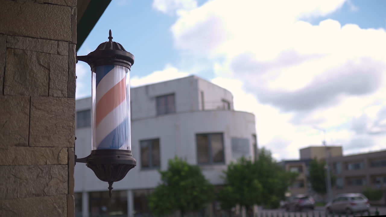 푸른 하늘과 구름을 배경으로 이발소 벽에서 회전하는 이발소