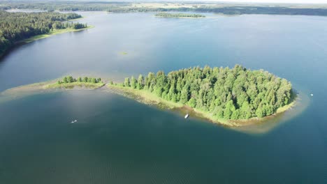 Lake-Plateliai-during-summer-showcasing-a-historical-island-with-tourists-enjoying-water-activities