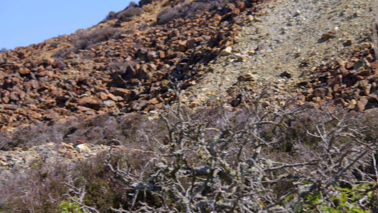 Slow zoom in to the roasted ore slag heap at mynydd parys mountain copper mine