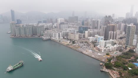 hong kong bay coastline and waterfront skyscrapers, aerial view