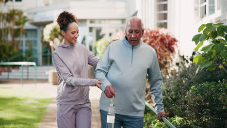 caregiver assisting senior man with walking exercise