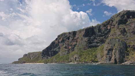 Sightseeing-on-boat-with-Playa-Fronton-beach-and-cliff-in-background,-Las-Galeras-in-Dominican-Republic