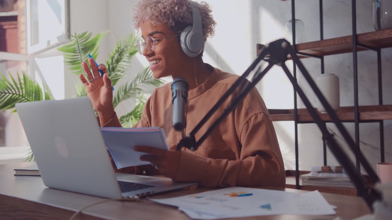Successful african american woman broadcasts radio program holding notepad