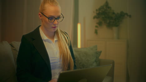 close up of woman working on laptop late evening