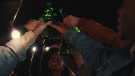 group of multi ethnic friends celebrating rooftop party making toast drinking enjoying reunion celebration on weekend social gathering at night