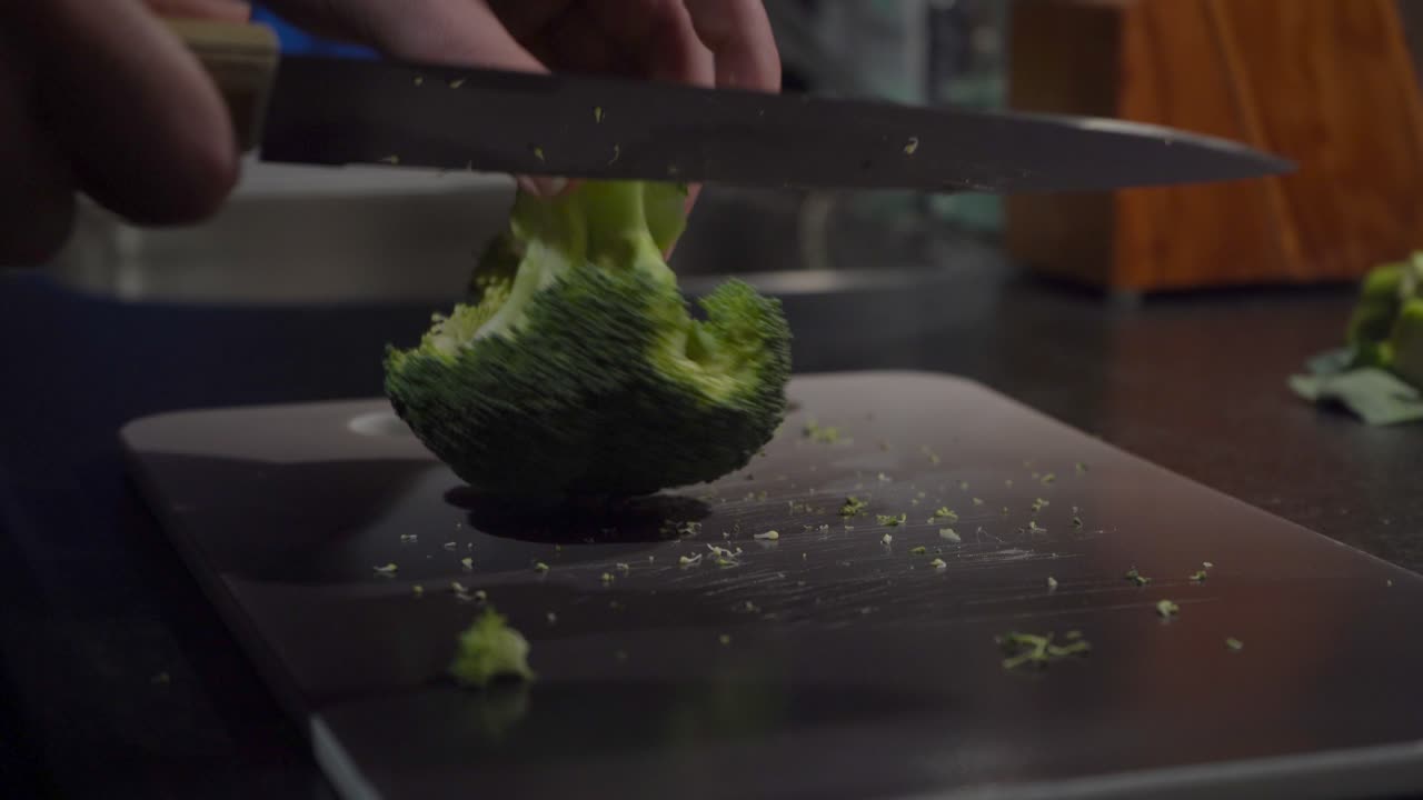 Low angle close-up: Broccoli crown cut into florets on cutting board