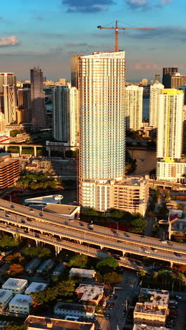 Stunning view of skyscrapers in the bright rays of setting sun. Panorama of Miami downtown from top. Vertical video