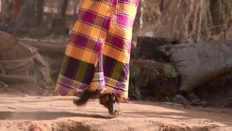 Unrecognizable-black-person-dancing-on-dusty-ground