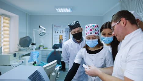 teacher pulls the dentistry detail from the apparatus. teaching students at medical school.