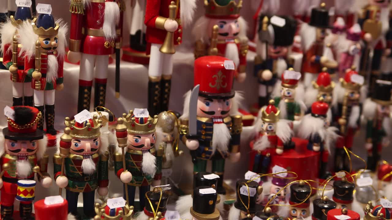 panning shot of toy wooden nutcrackers in a shop at heidelberg, germany at a Festive Christmas market in Europe