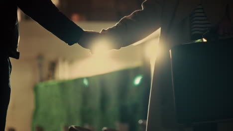 two people exchange mysterious briefcase in dark alley or street at night. silhouettes of government agents or spy criminal transaction or corruption. fraud and illegal bribe payment in shady deal
