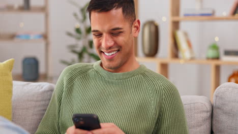 Laughing,-phone-and-relax-with-man-on-sofa