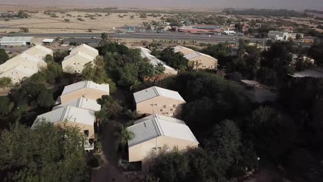 Aerial:-top-view-of-rooftops-in-the-small-village-of-Yotvata-in-the-middle-of-the-desert,-Israel