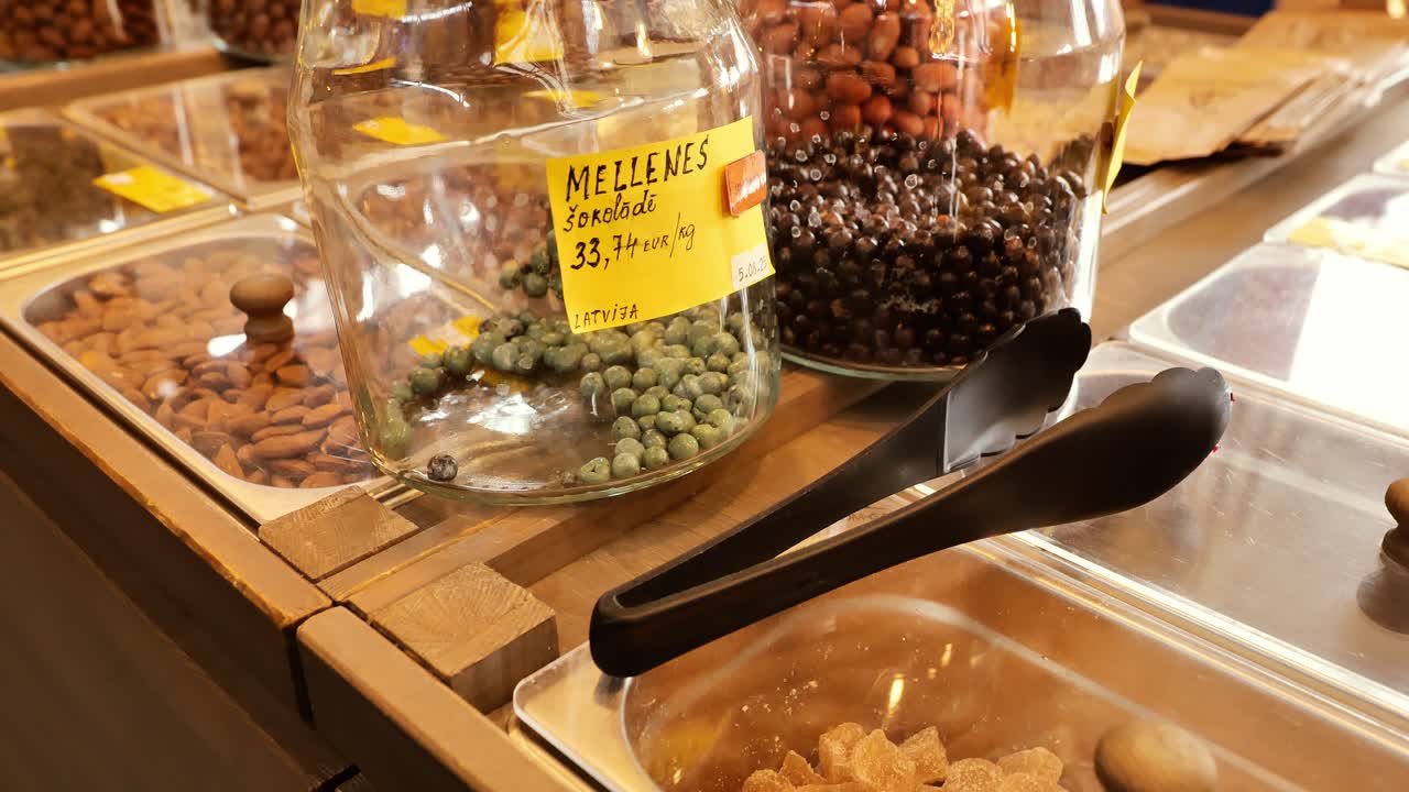 Latvian bulk market jars filled with chocolate-covered berries, rustic textures