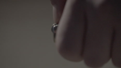 person manipulating a small metal object