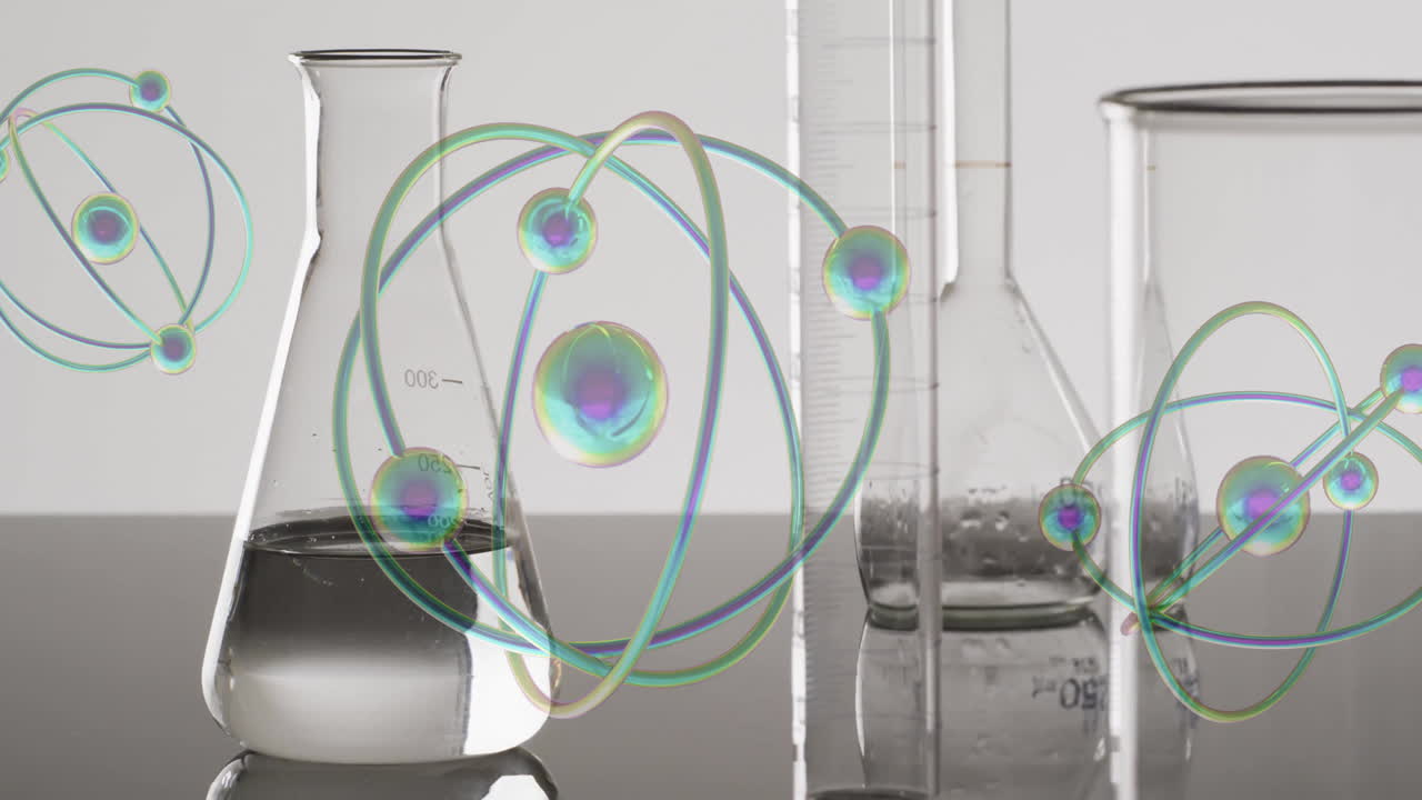 회색 바탕에 실험실 접시 위에 움직이는 원자의 애니메이션