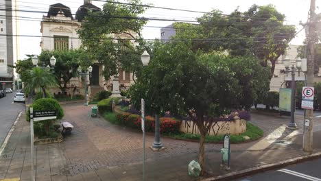 cars and motorcycle riding in front of a palace