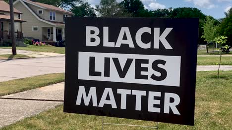 black lives matter sign in the front yard of a suburban city home