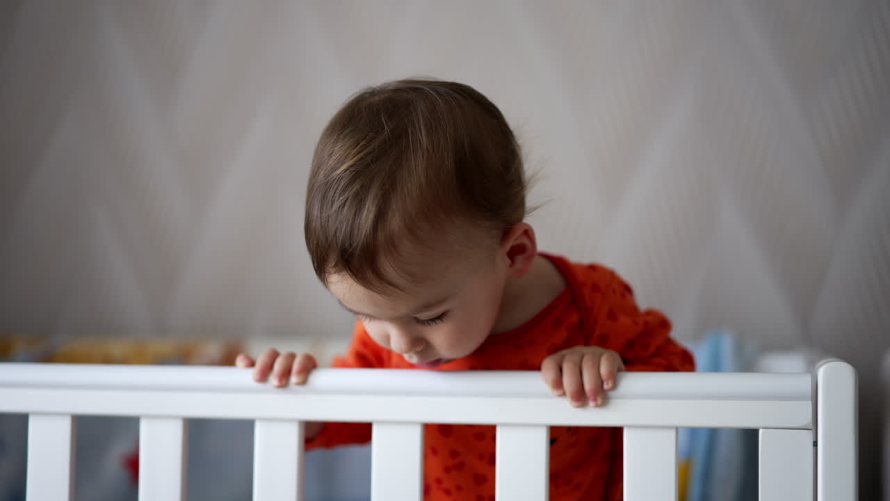 Baby reaching over crib
