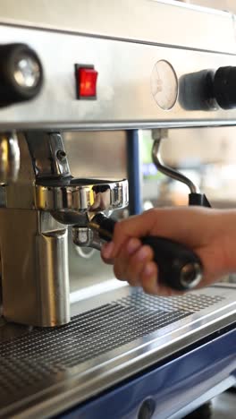 barista using espresso machine