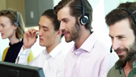 Team-of-customer-service-executives-working-at-desk