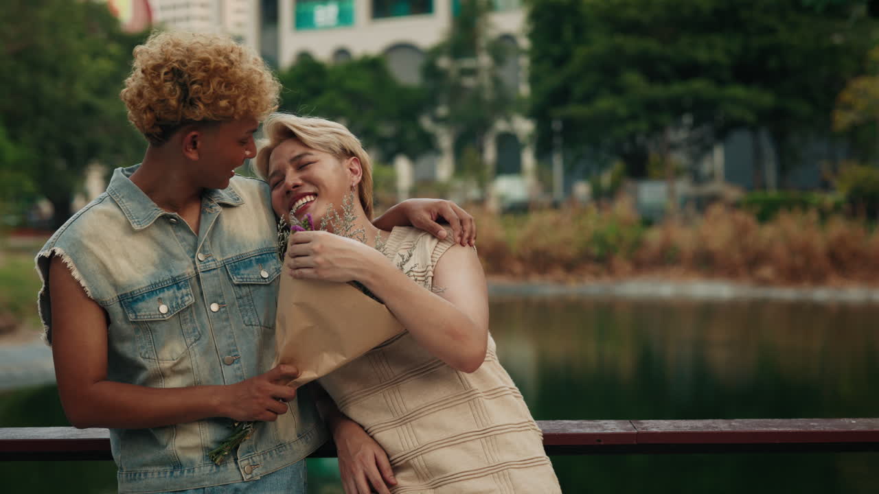 Loving couple sharing a moment with flowers by the lake