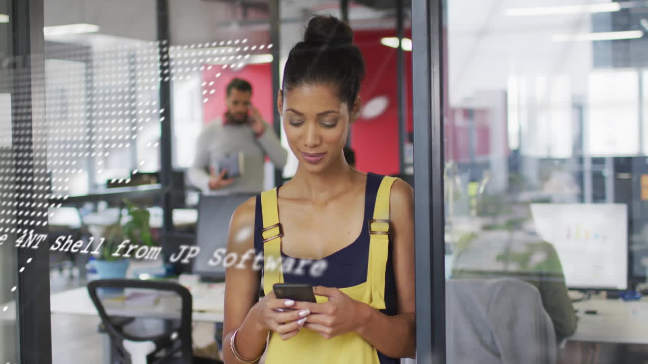 Animation of data processing and world map over diverse colleagues using smartphone in office