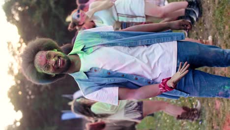 swipe up video of african man in holi colors