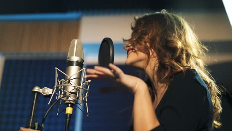 beautiful young singer who recorded a song in a professional recording studio. female vocal