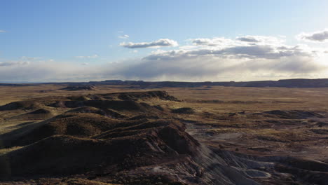 drone flying over a dusty badland to get a panoramic view of the location