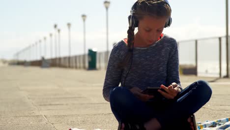 girl using digital tablet at beach 4k