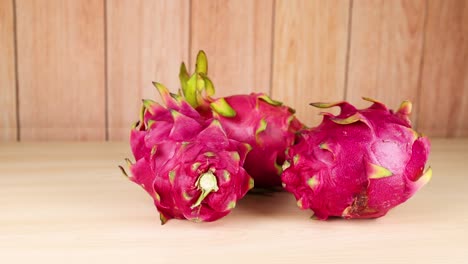 dragon fruits arranged on a wooden table