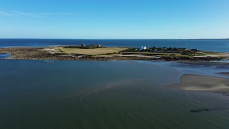aerial drone footage captures the stunning tatihou island in normandy on a bright sunny day, with its historic fortifications,