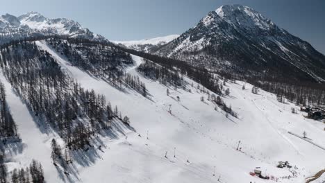Winter-ski-slopes-with-skiers-skiing-aerial-view-captured-by-drone
