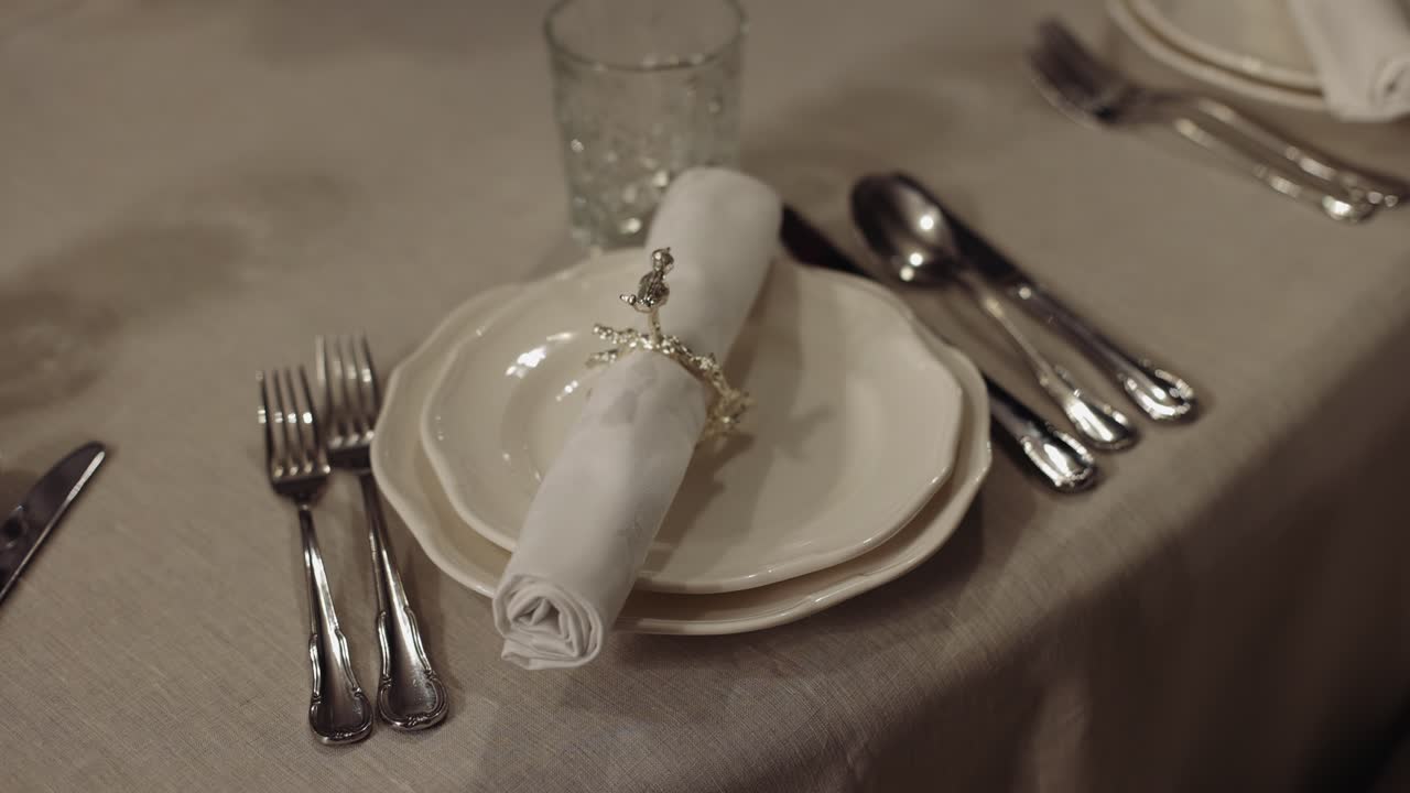 Elegant Table Setting with White Plates and Silverware