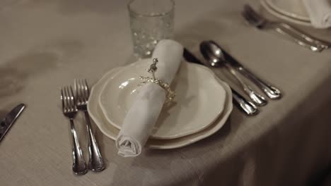 elegant table setting with white plates and silverware