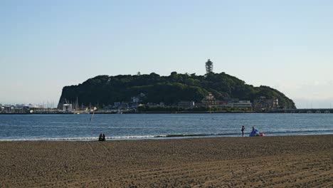 Slow-motion-cinematic-walk-along-coastline-of-Enoshima,-Kanagawa