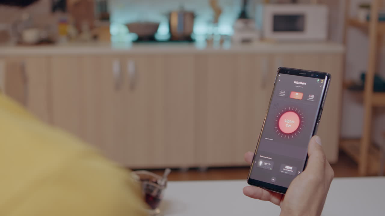 Person looking at smartphone with lights controlling software