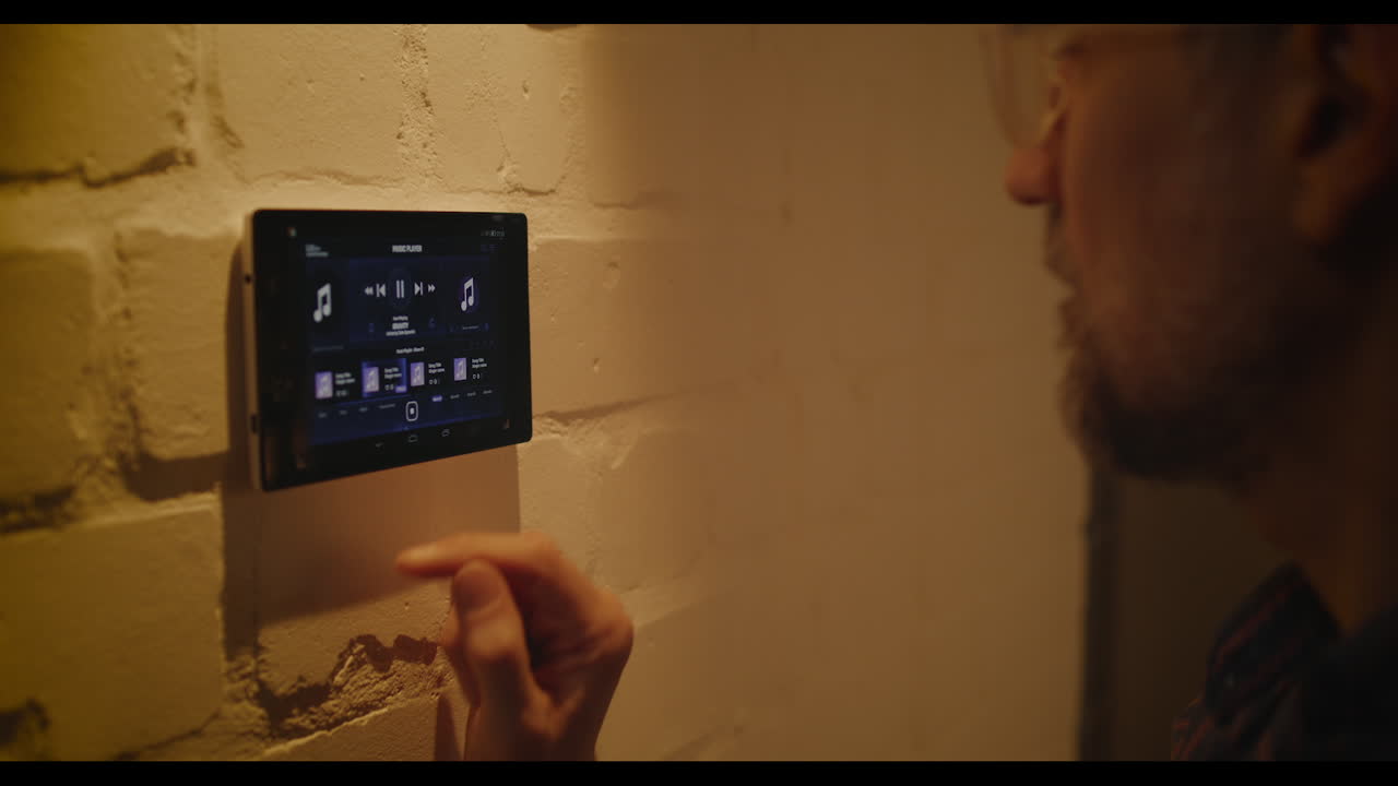 Man Interacting with Smart Home Wall Panel