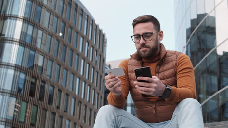 man proceeding online payment with credit card