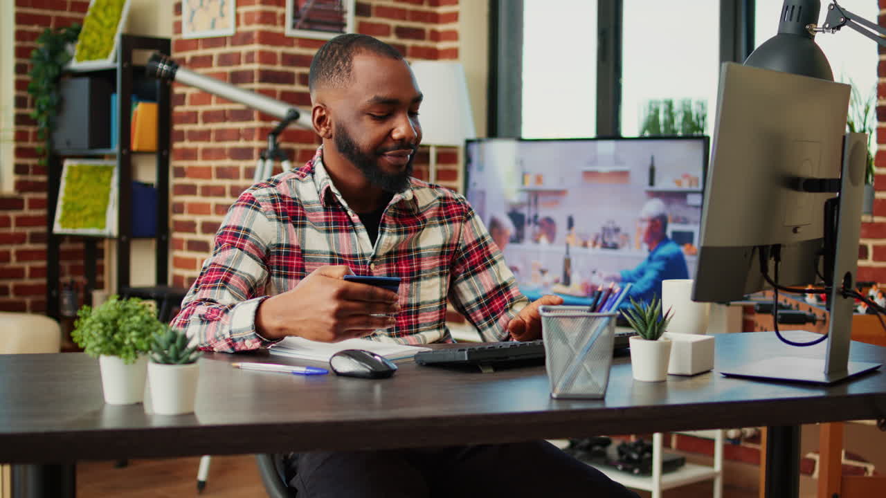Man working at home with credit card and computer